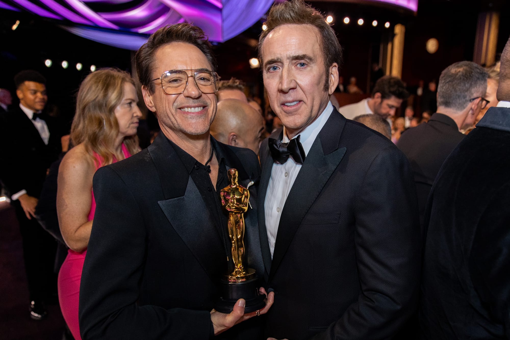 Robert Downey Jr. holds his Oscar statuette with Nicolas Cage