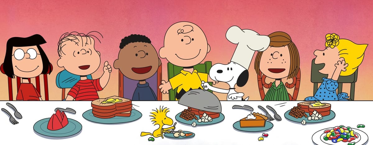 Artwork from A Charlie Brown Thanksgiving, showing the Peanuts gang at a large dinner table.